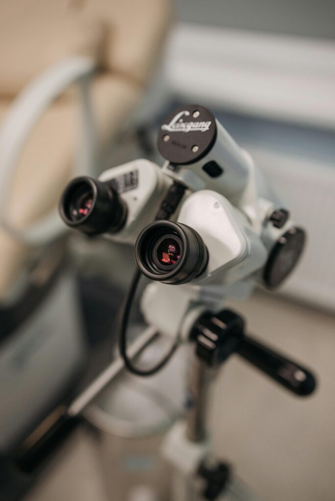 A close-up view of a medical microscope with binocular lenses used for diagnostic purposes in healthcare settings.